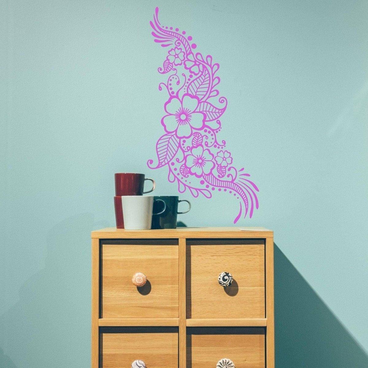 Henna art inspired wall decal in pink above a wooden drawer unit with colorful mugs, adding elegance to the room.