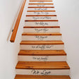 Stylish staircase with vinyl quote decals enhancing home decor and transformation.