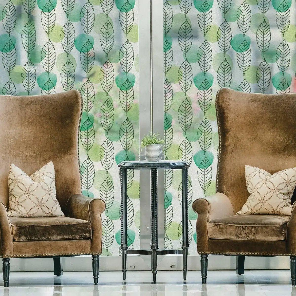 Stylish leaf design etched glass film providing privacy and elegance in a cozy living space with brown chairs.