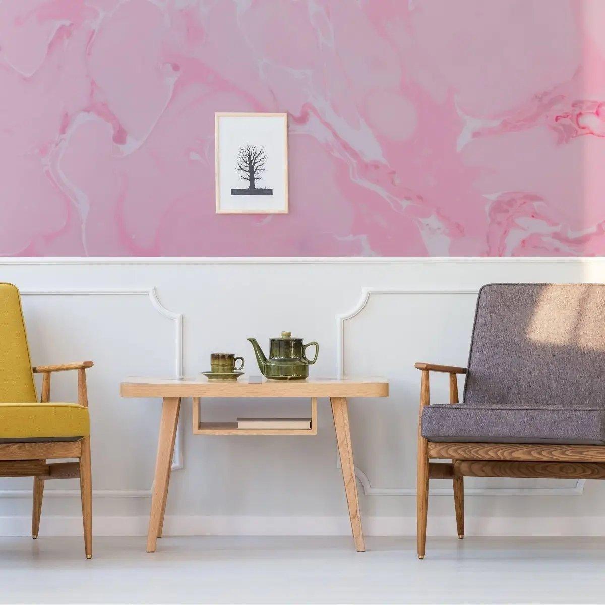 Elegant pink marble wallpaper enhancing a cozy living room with a wooden table and stylish seating.