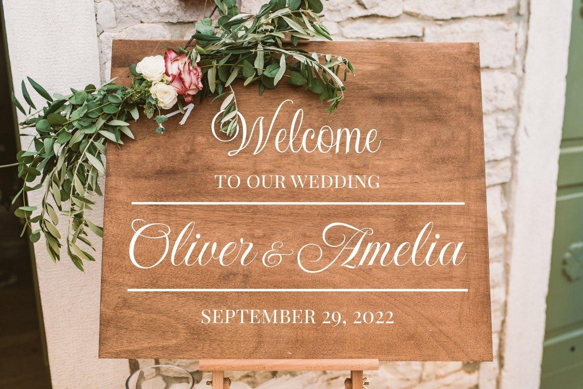 Personalized wooden wedding welcome sign for Oliver & Amelia, featuring elegant typography and floral decor.