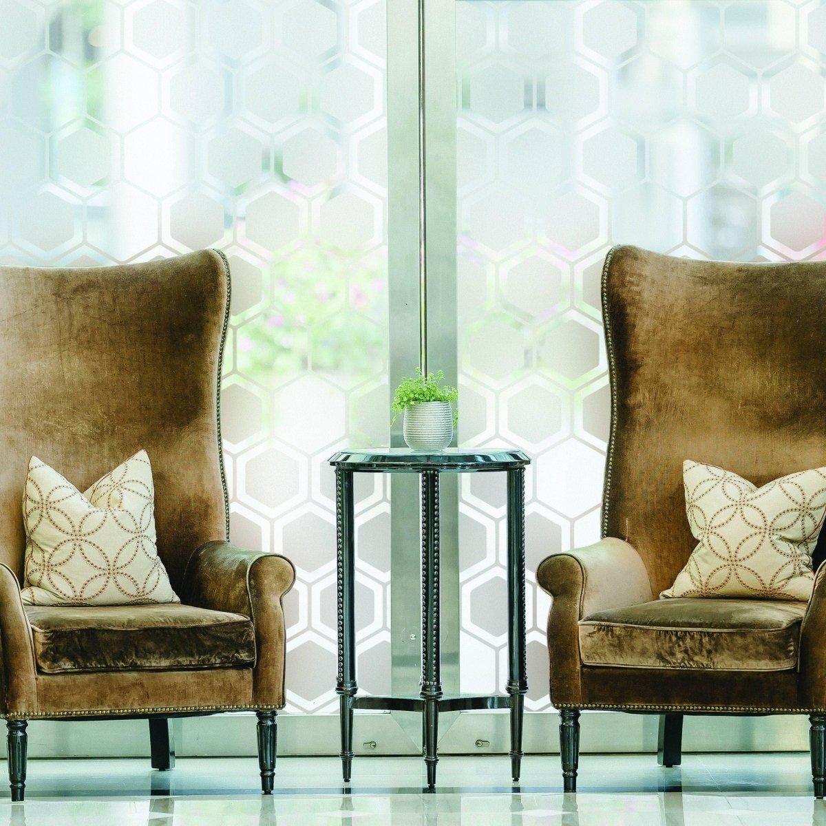 Stylish frosted window film showcased behind elegant armchairs, adding privacy and aesthetic appeal to the elegant space.