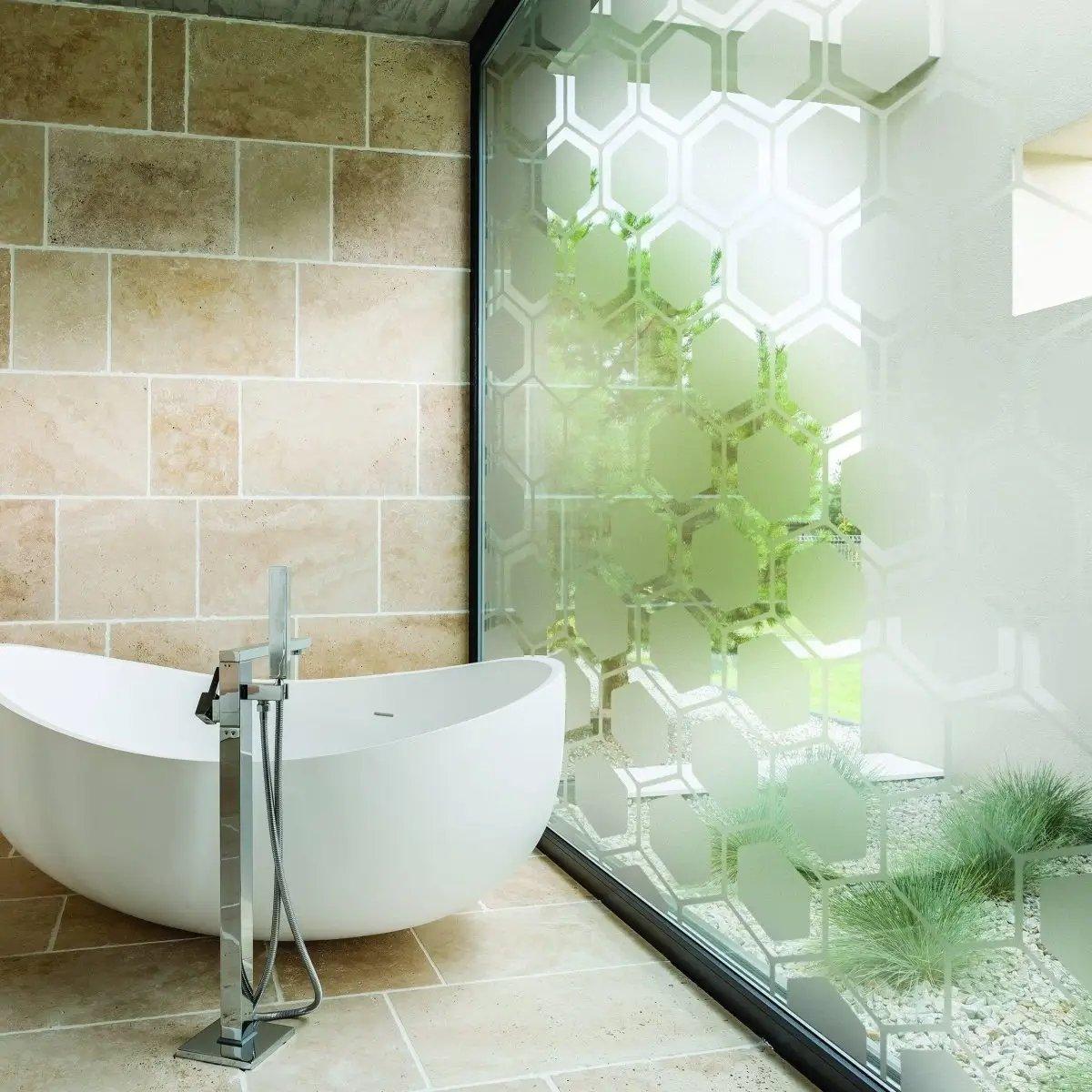 Elegant frosted window film in a modern bathroom, providing privacy while allowing natural light.