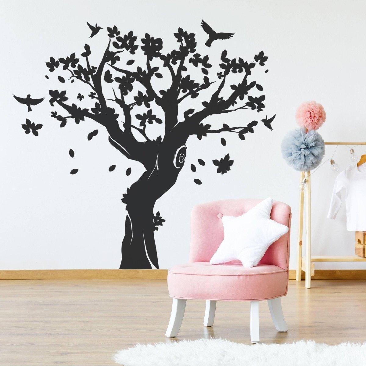 Contemporary tree wall art sticker in black vinyl on nursery wall, adding charm to kids' room decor.