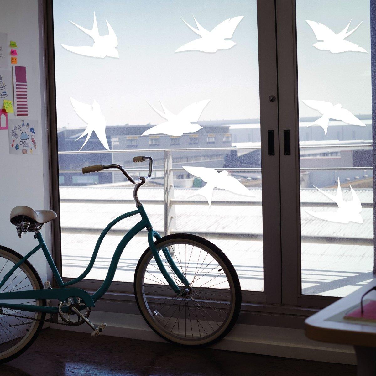 Frosted bird silhouette decals on glass window, enhancing aesthetics while preventing bird collisions.