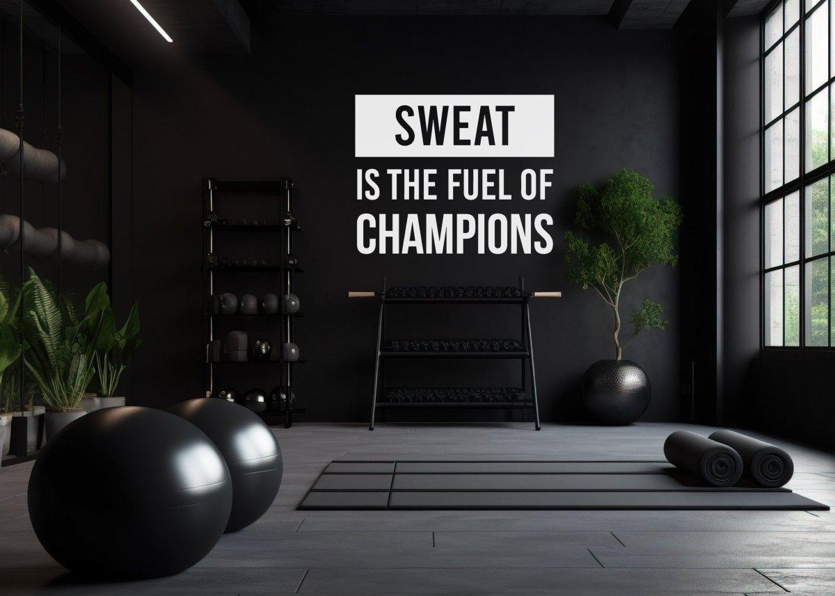 Fitness motivational wall decal in modern gym with quote 'Sweat is the fuel of champions' and workout equipment.