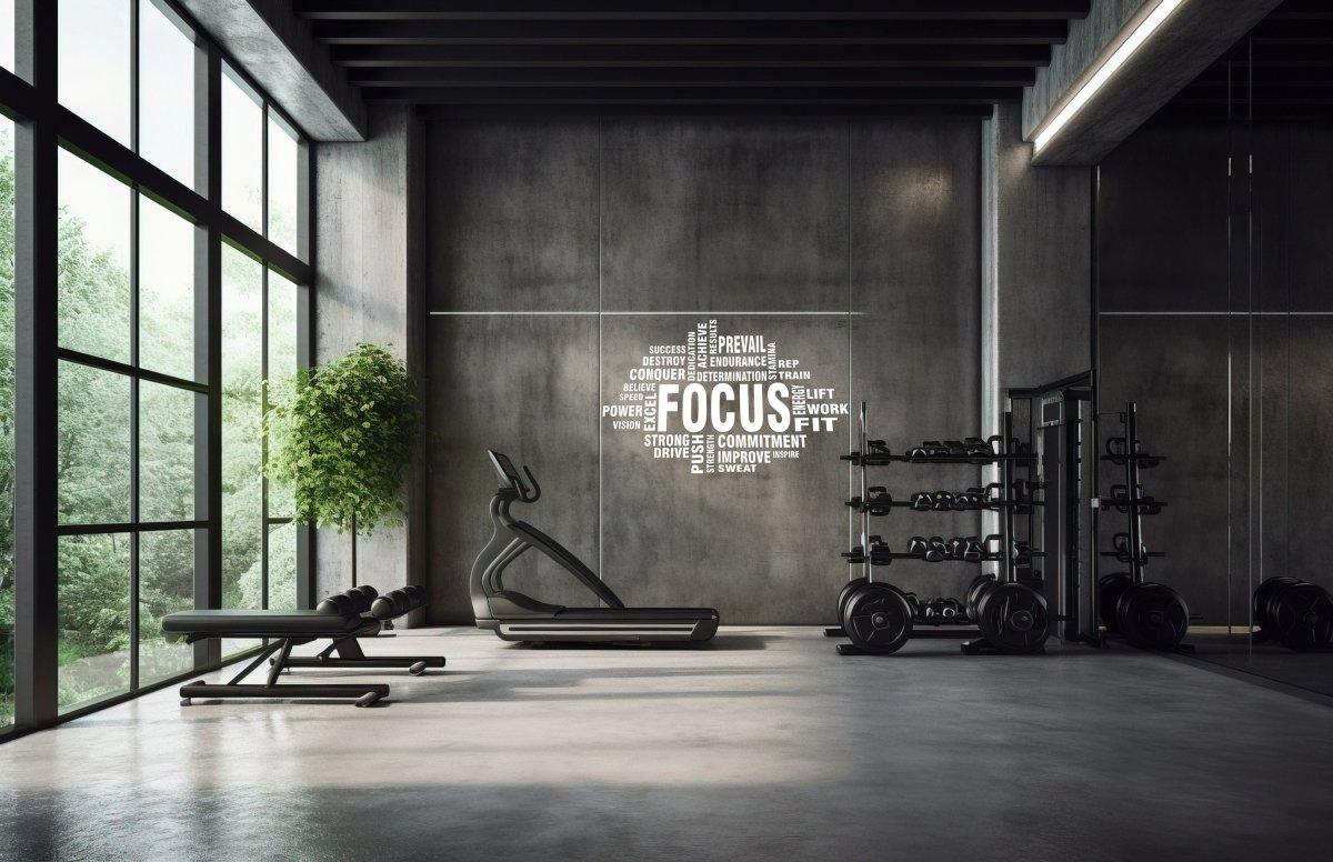 Inspirational fitness wall stickers with the word 'FOCUS' in a modern gym setting.