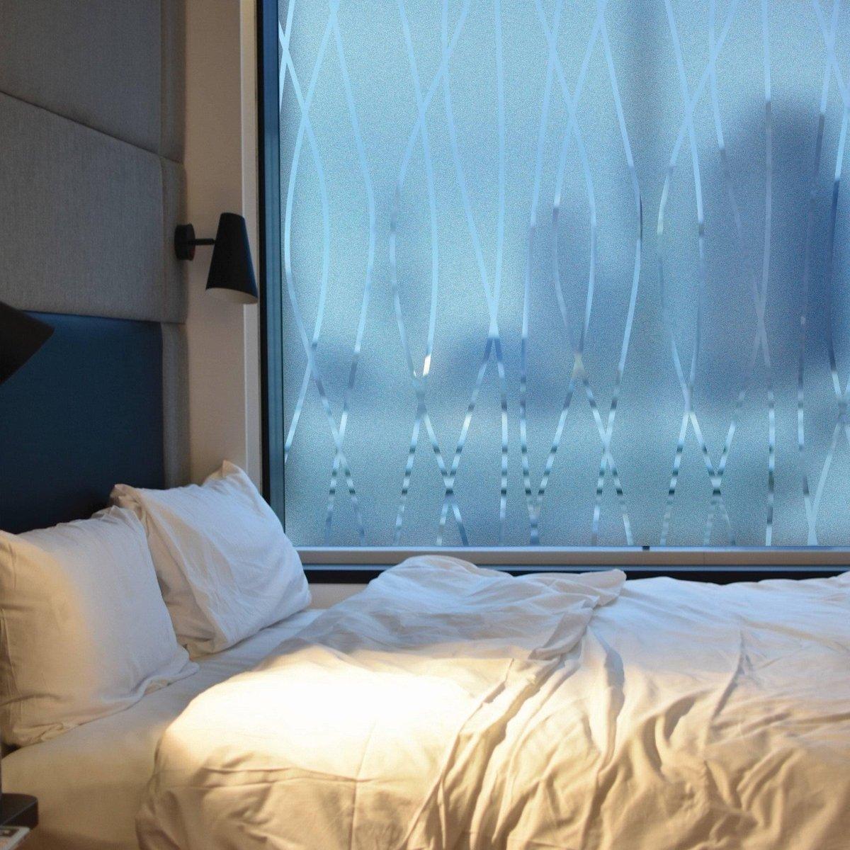 Frosted glass door sticker in a cozy bedroom, providing elegance and privacy while allowing natural light.