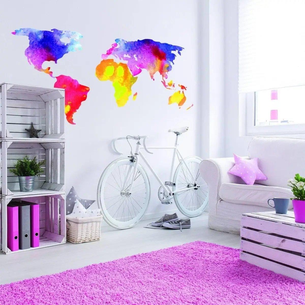 Colorful world map wall decal transforming a bright and modern living space with bicycle and pink rug.