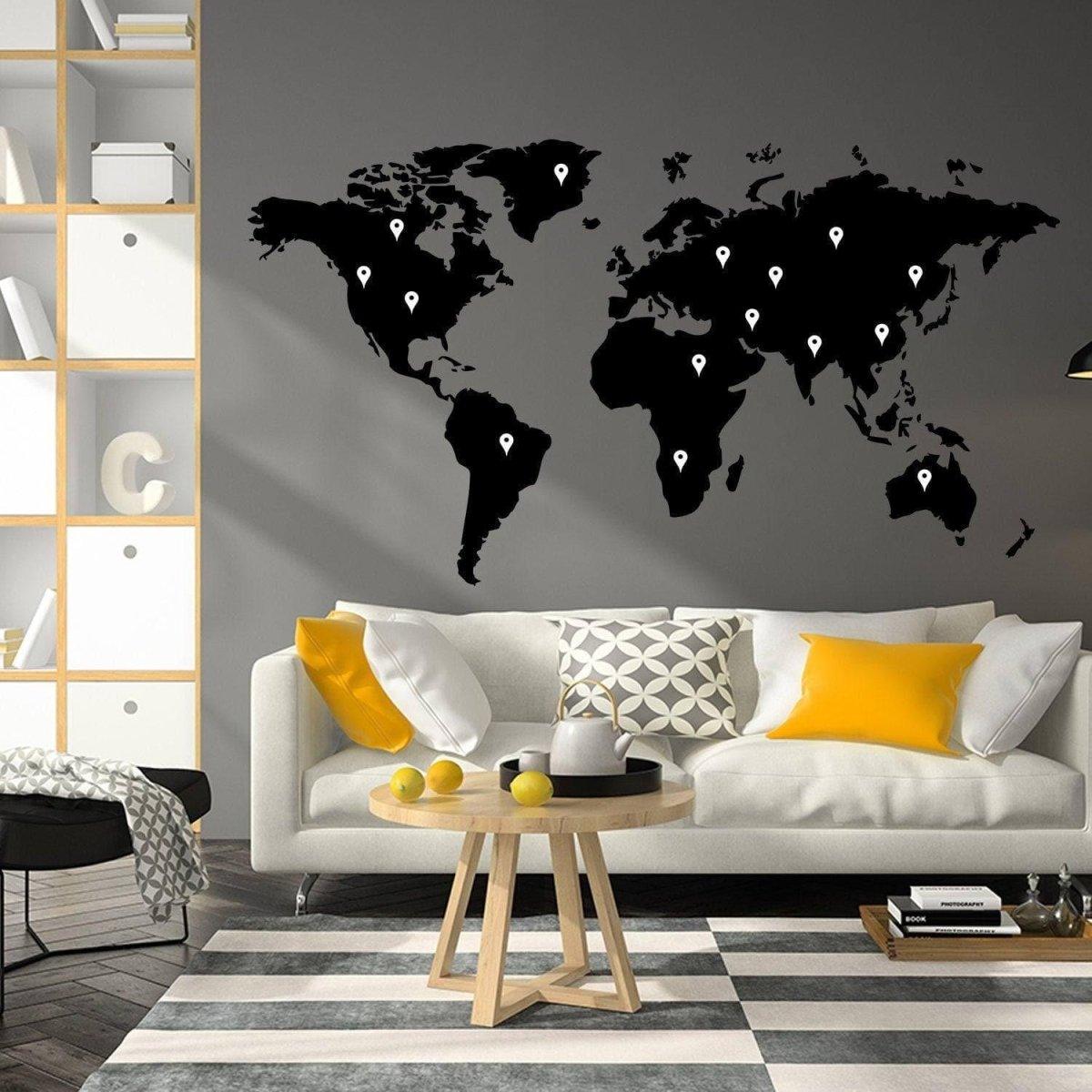 Artistic world map vinyl sticker on wall above modern sofa, perfect for travel lovers' decor.