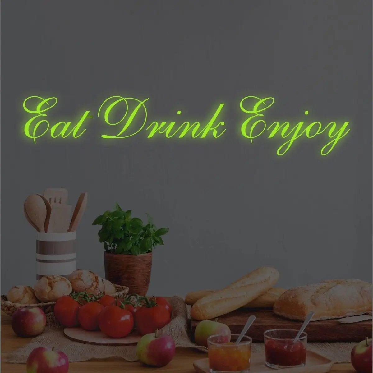 Illuminated 'Eat Drink Enjoy' vinyl decal on a kitchen wall with food and drinks.