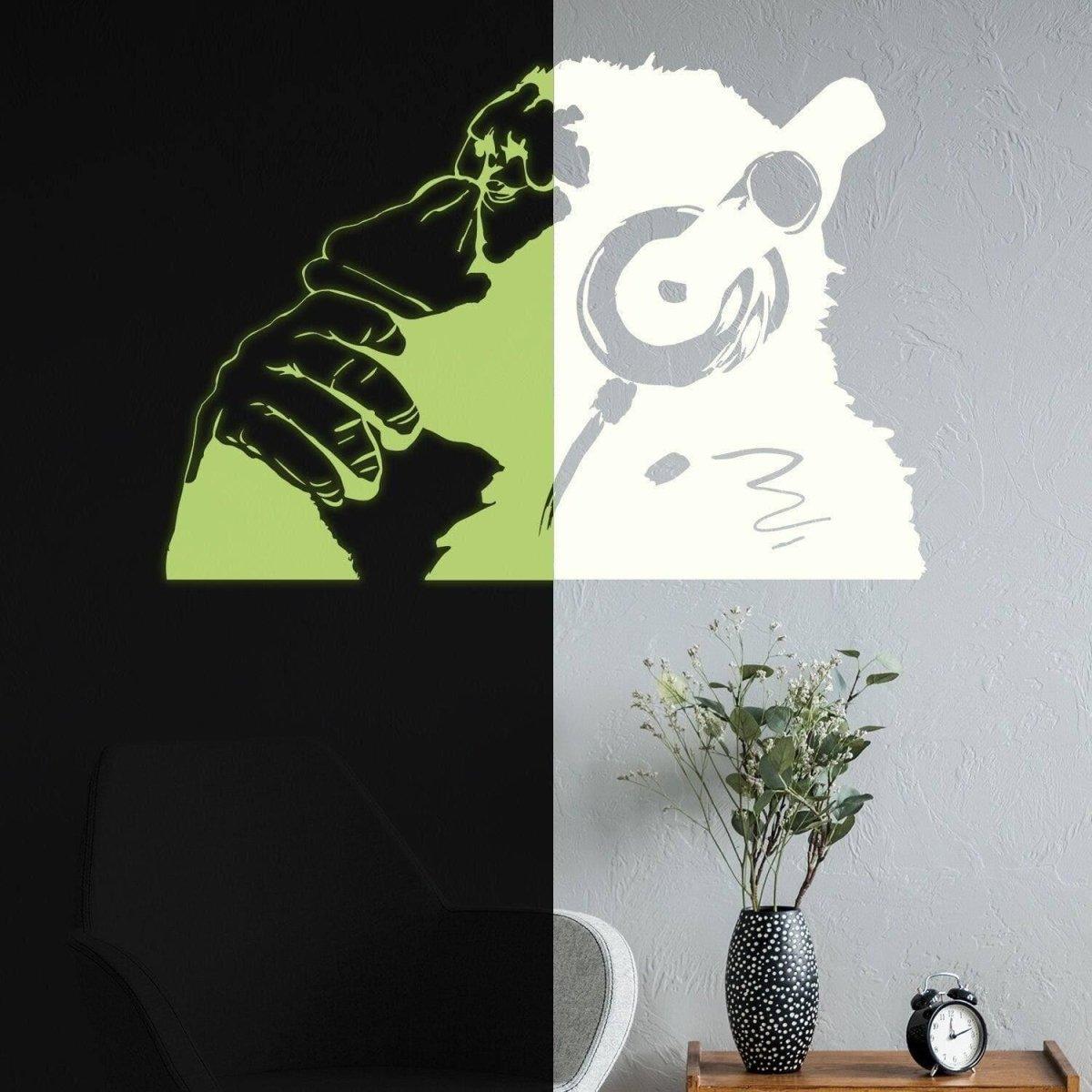 Glowing vinyl wall decal of a monkey with headphones, creating a unique luminescent graffiti art effect.
