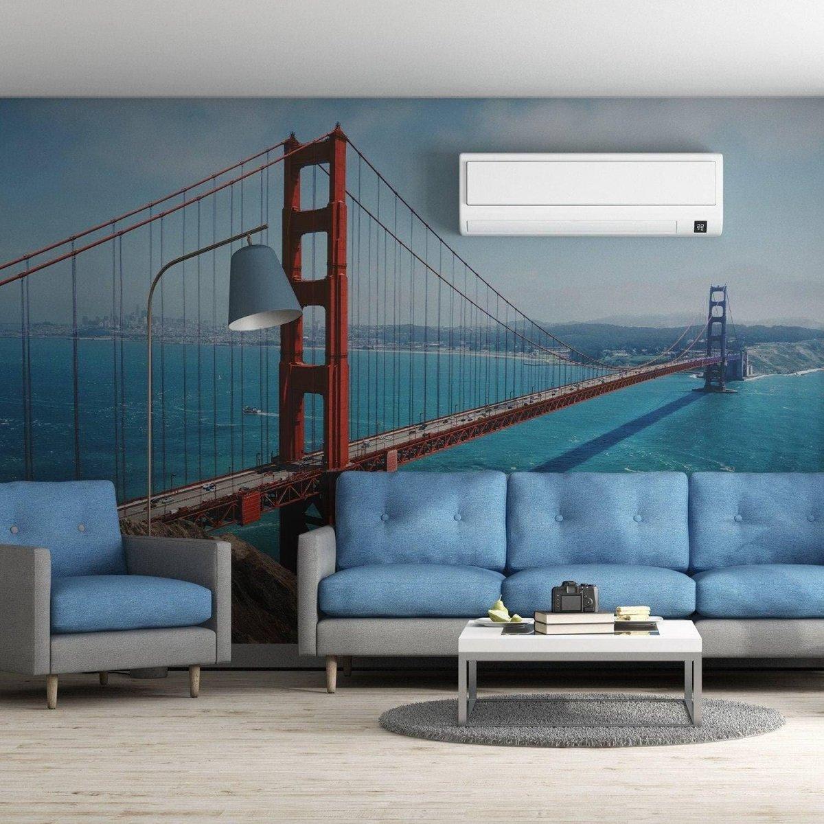 Golden Gate Bridge Vinyl Wall Decal in modern living room with blue sofa and air conditioner.