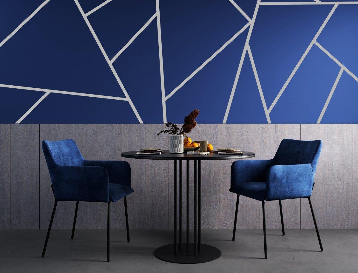 Elegant blue geometric wall stickers with thin gold lines in modern dining area with blue chairs and round table.