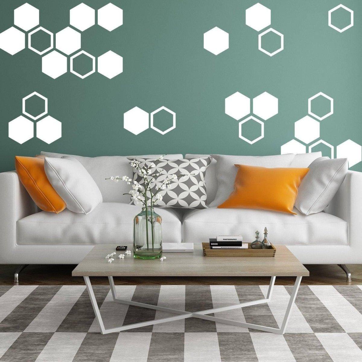 Elegant living room with hexagon wall decals in white on green wall, showcasing golden honeycomb aesthetic.
