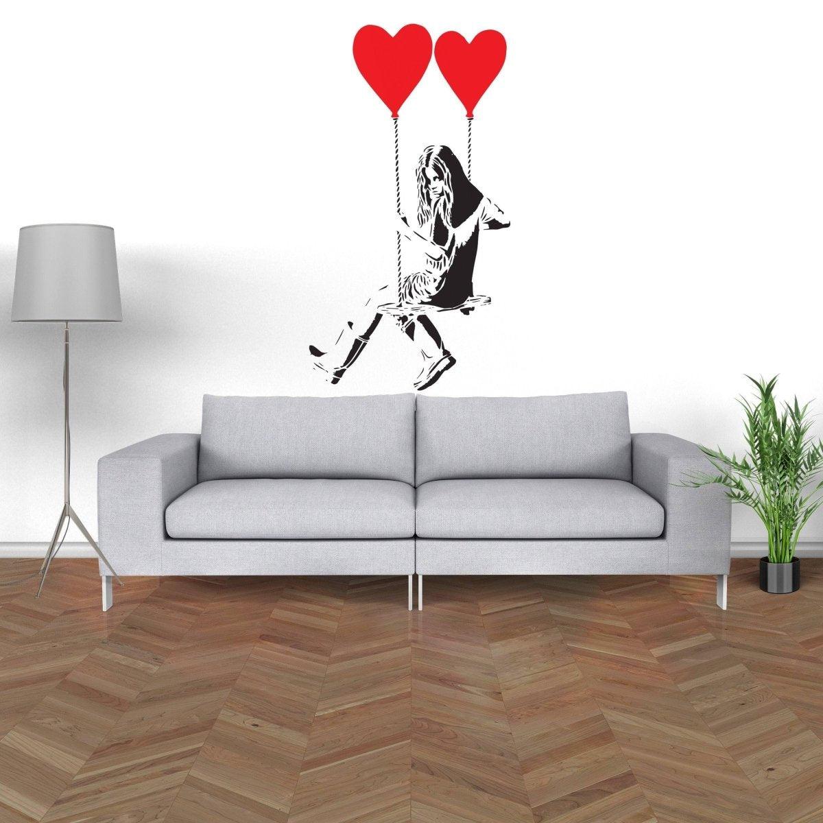 Vinyl heart balloon wall decal featuring a girl on a swing, adding creative decor to a living room.