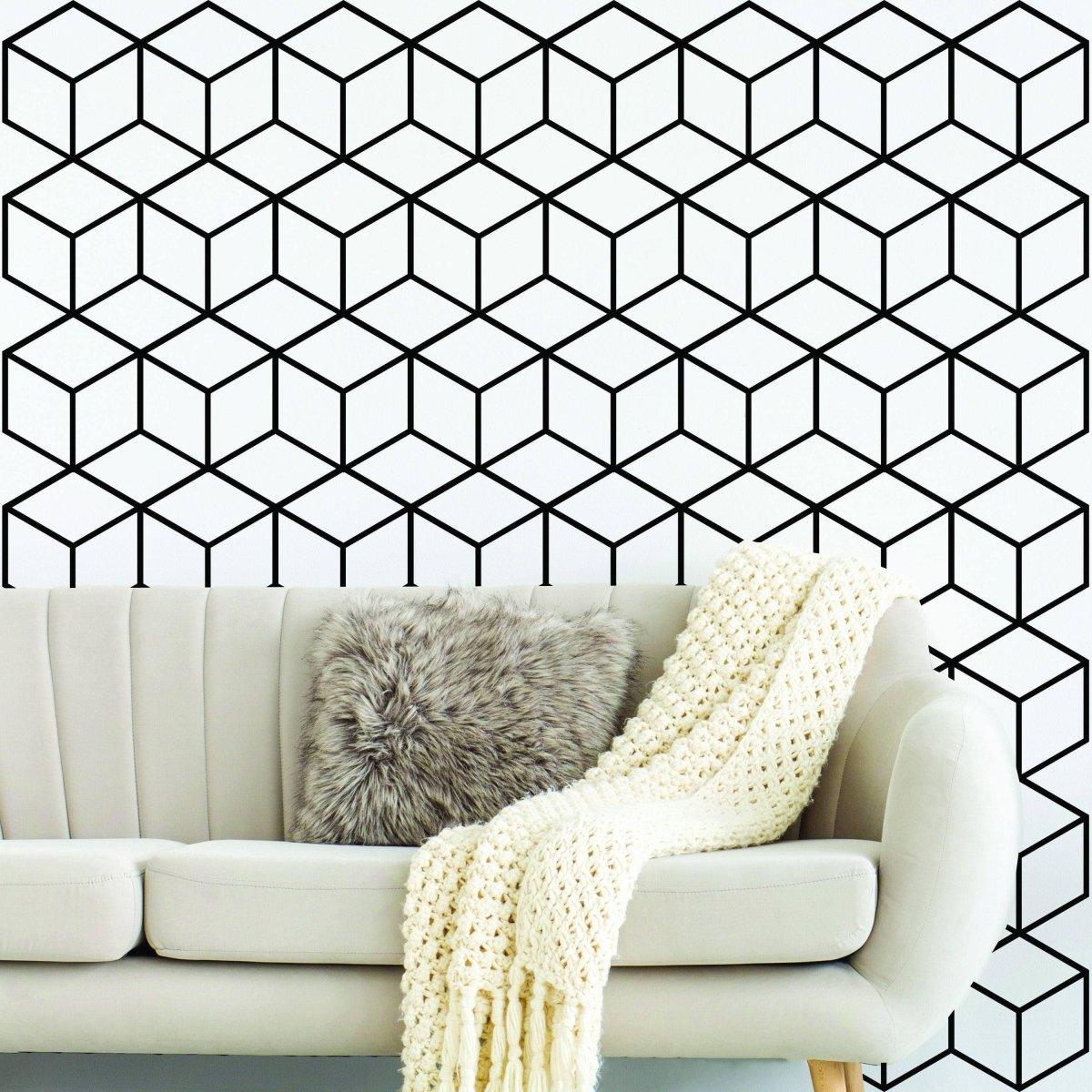 Hexagonal honeycomb wall decal with geometric pattern behind a stylish sofa and cozy throw blanket.