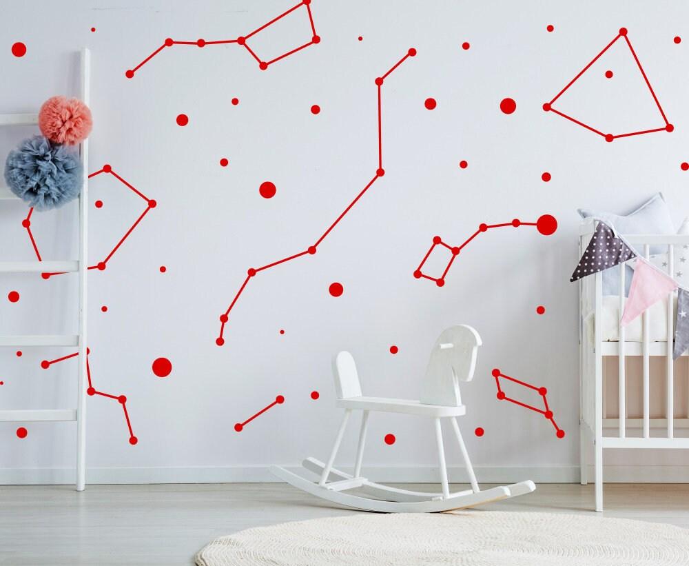 Red constellation wall stickers showcasing zodiac designs in a nursery with a rocking chair.