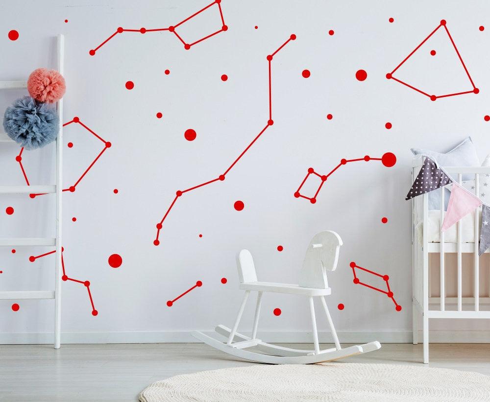 Red constellation vinyl wall decals on a nursery wall, adding a celestial theme to the room.