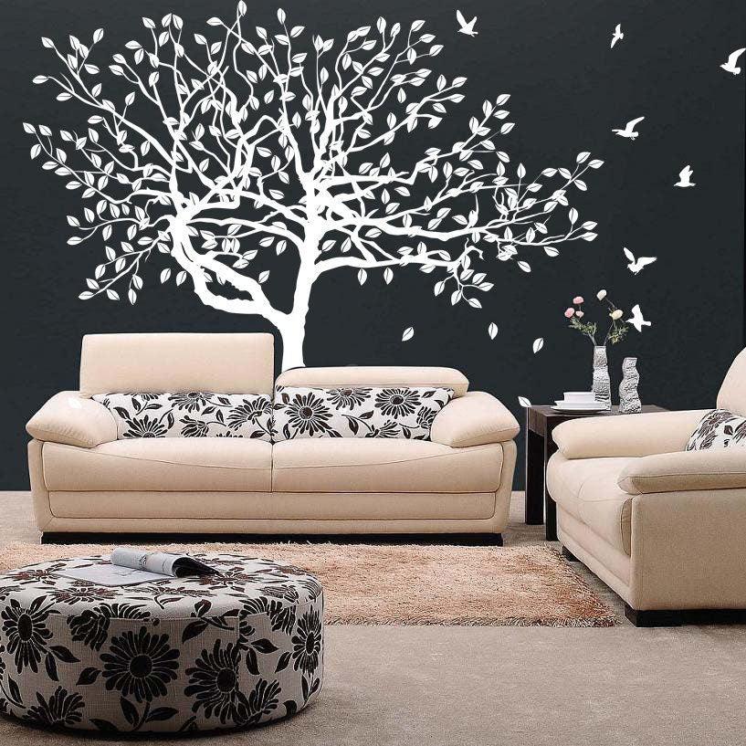Tree wall decal sticker on dark wall above a beige sofa, adding nature-inspired decor to the living space.
