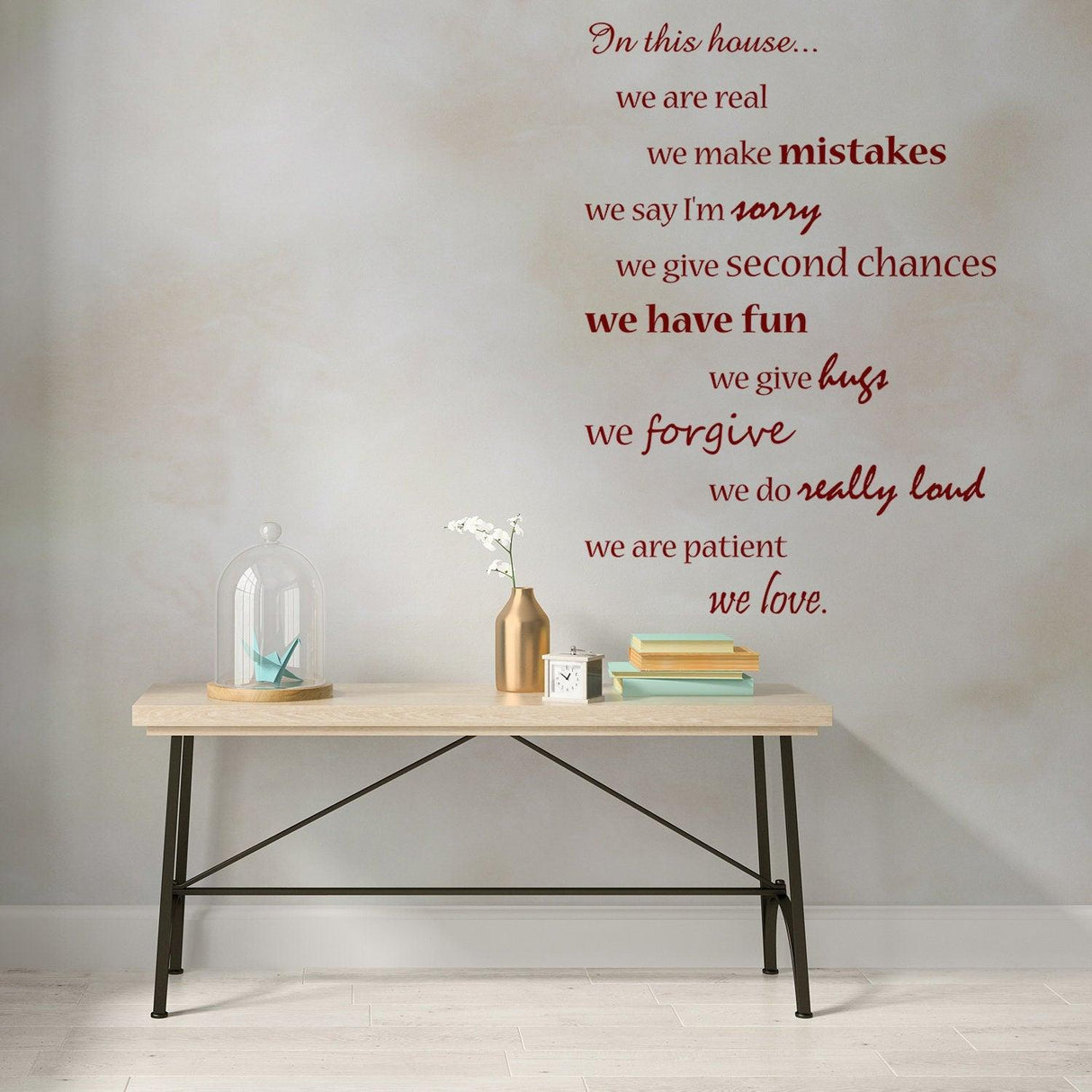 House wall quote sticker featuring family rules and inspirational phrases above a wooden table.
