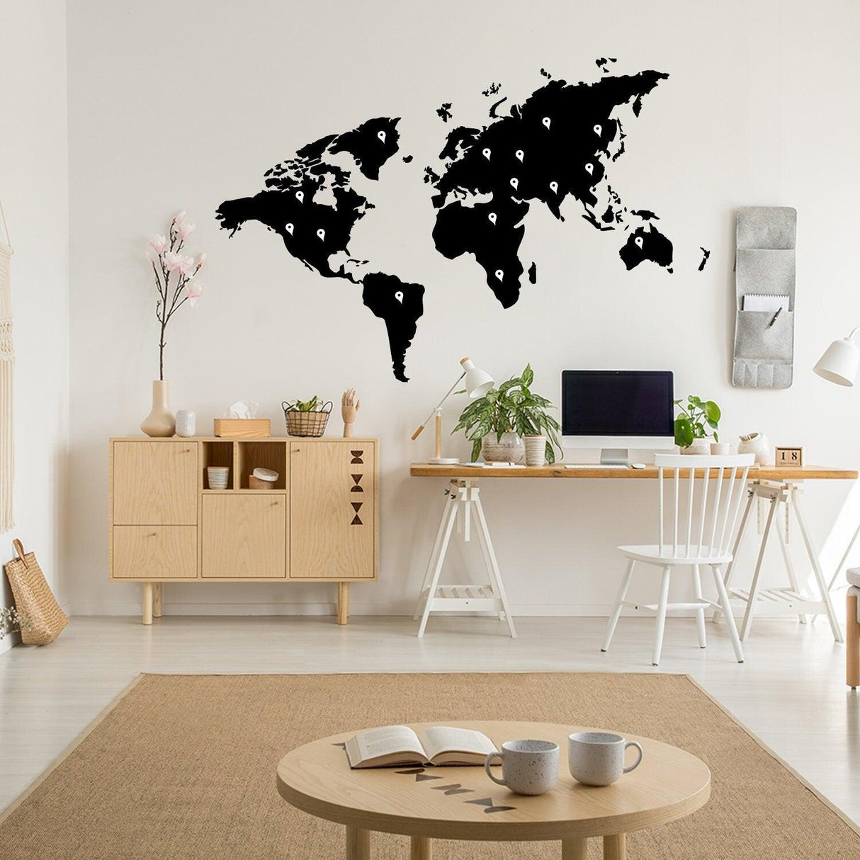 World map vinyl sticker wall art in a modern workspace with plants and wooden decor.