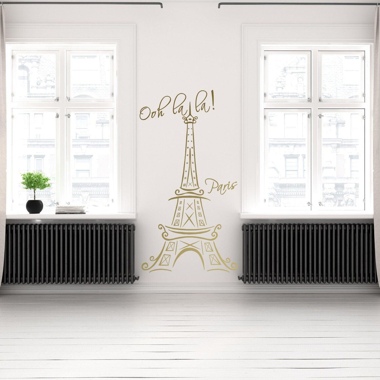 Eiffel Tower wall sticker with 'Ooh la la!' text, adding Parisian charm to a modern room interior.