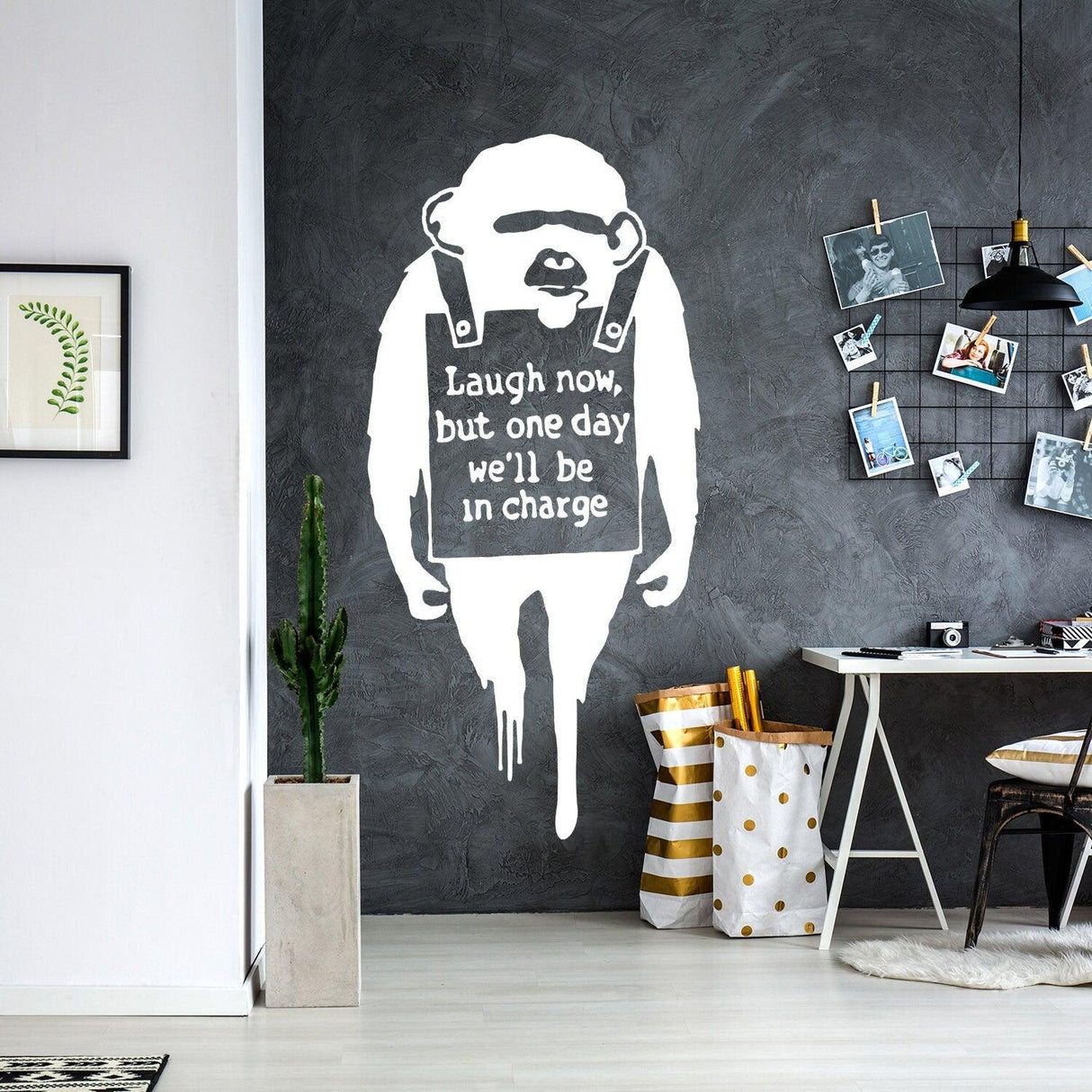 Banksy Monkey Wall Sticker in modern living room with quote 'Laugh now, but one day we'll be in charge'