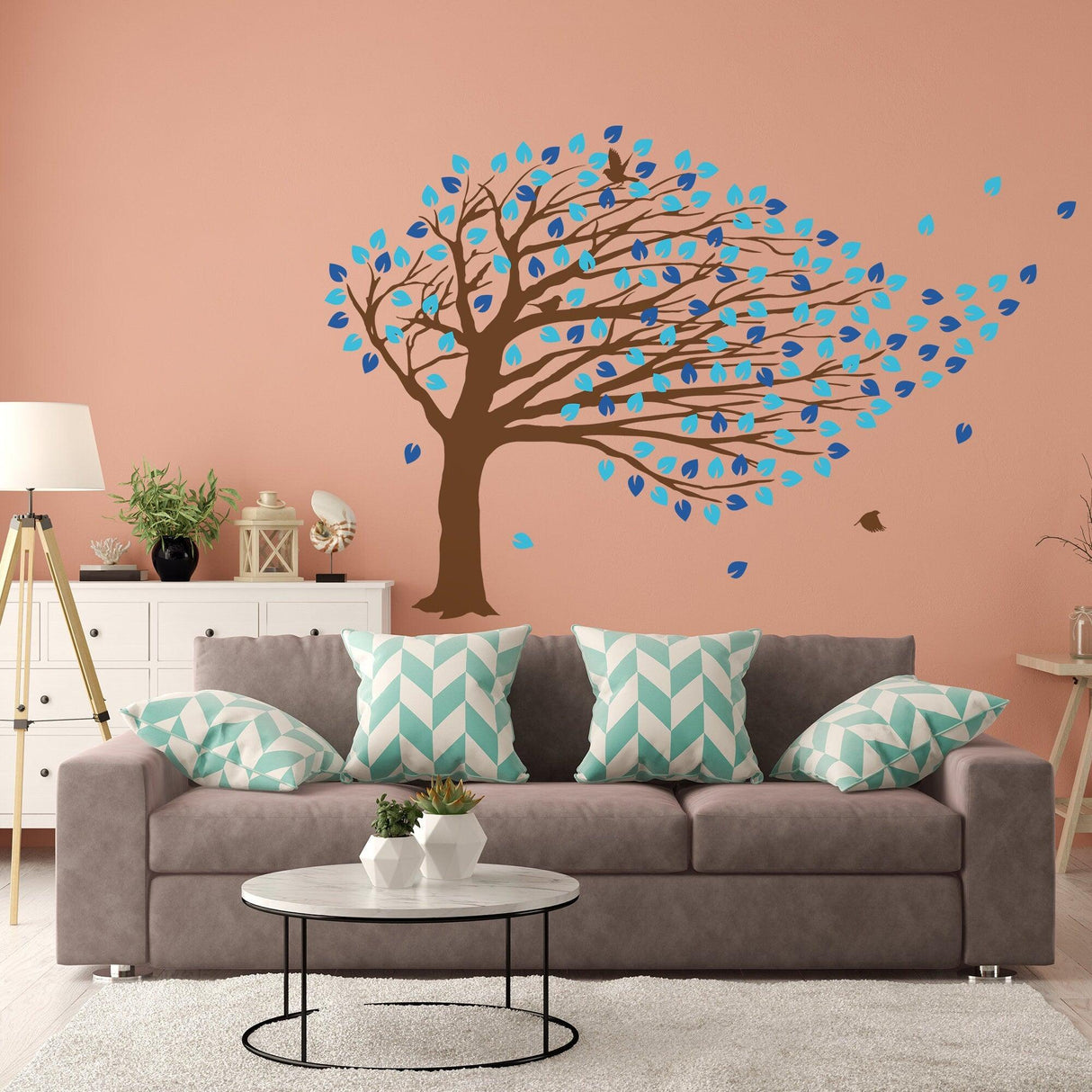 Whimsical tree wall decal in a nursery with teal leaves and swirling branches, enhancing nursery decor.