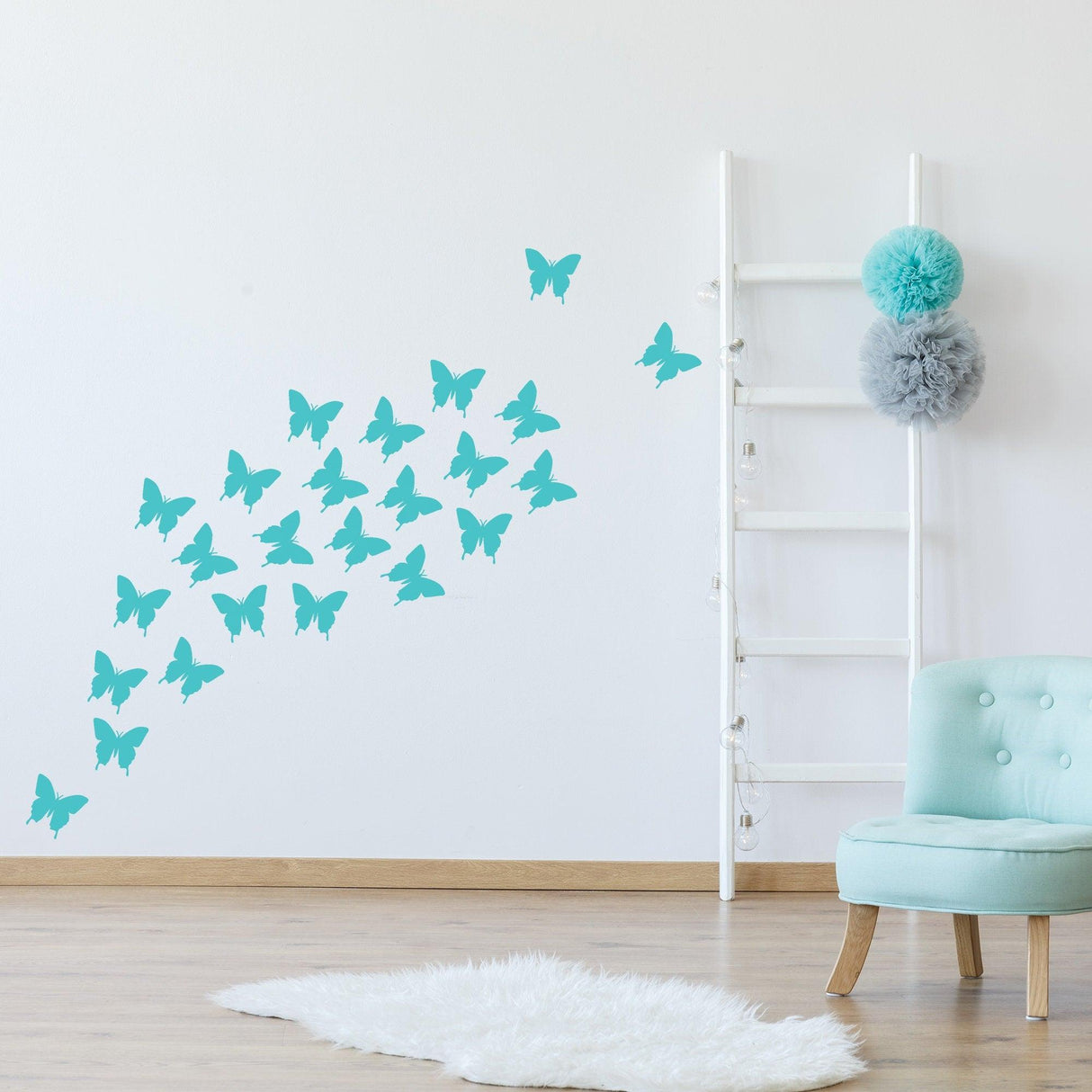 Blue butterfly wall stickers in a modern room with a cozy chair and ladder decor.