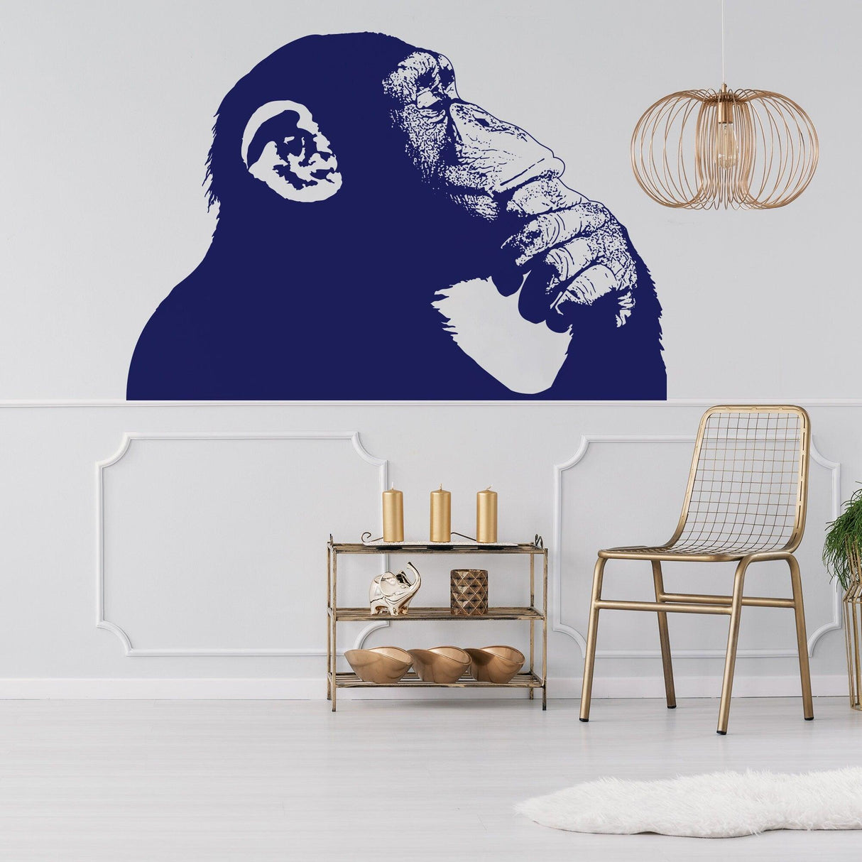 Thinking Monkey wall sticker in blue on a white wall, adding creativity to home decor and inspired by Banksy street art.