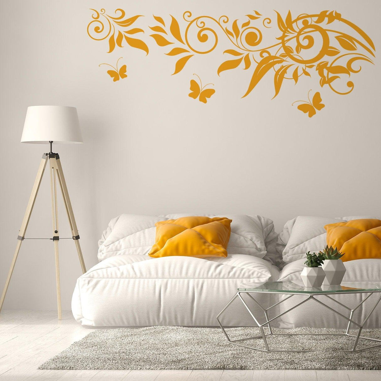 Decorative yellow butterfly and floral vinyl wall art above a cozy white couch with yellow cushions.