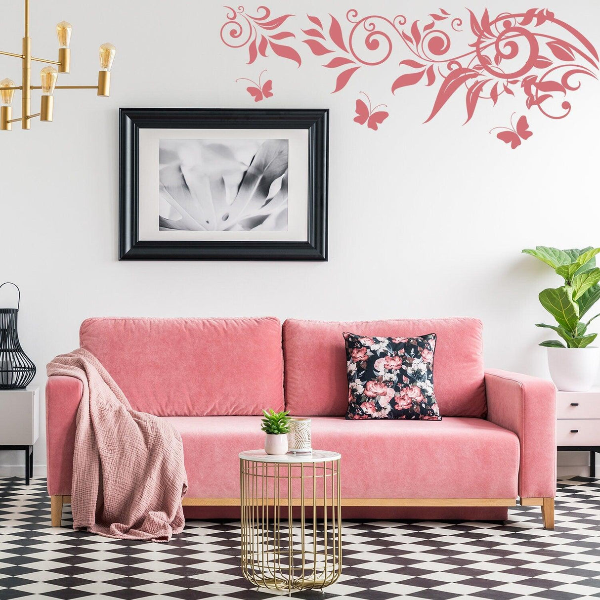 A modern living room featuring a pink sofa with floral pillows and butterfly wall decals, creating a whimsical decor.