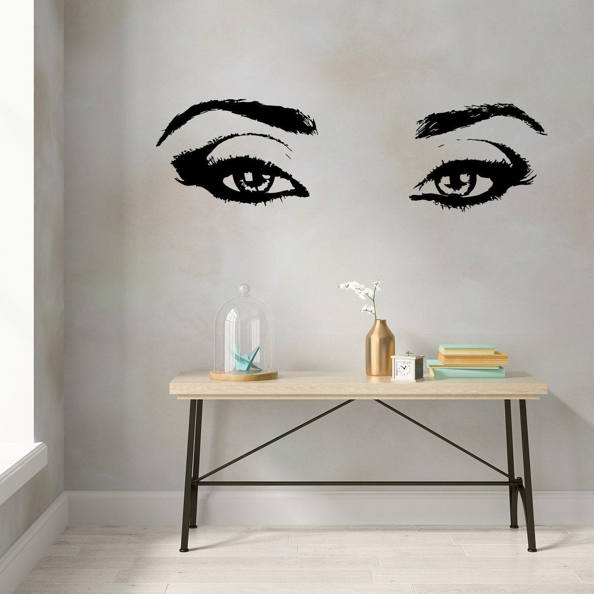 Stylish woman eye vinyl wall sticker in black on pastel wall, enhancing beauty decor in a modern salon.