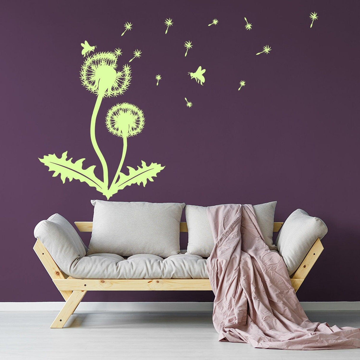 Dandelion vinyl wall decal with butterflies on purple wall above a cozy couch with throw blanket.