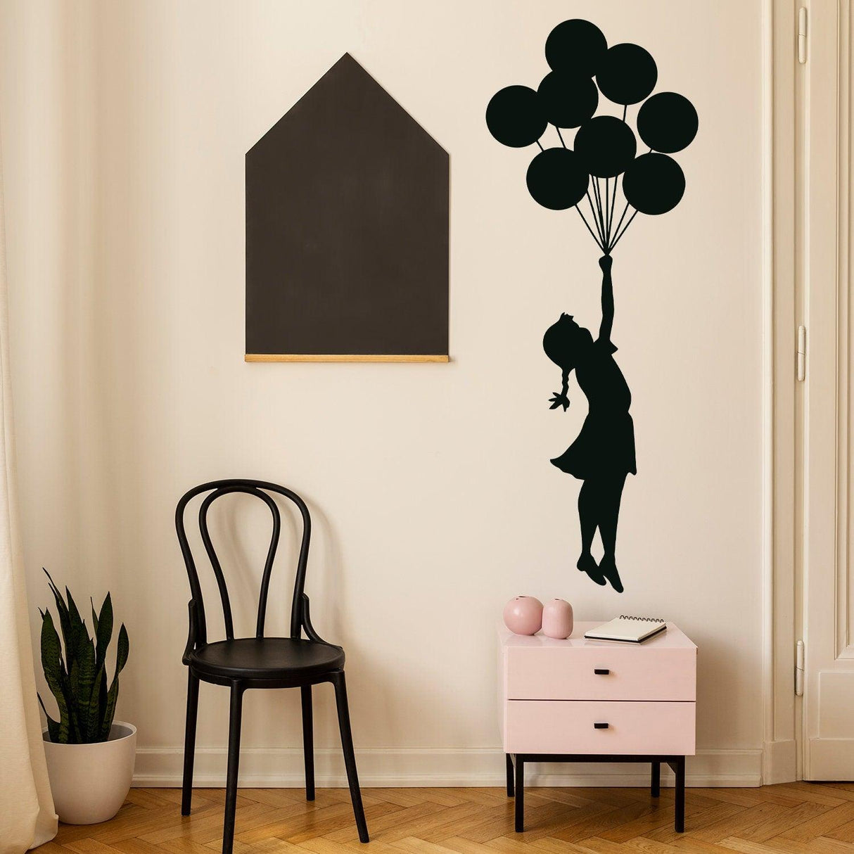 Balloon Girl Banksy wall sticker in nursery decor, featuring a girl floating with balloons and stylish furniture.