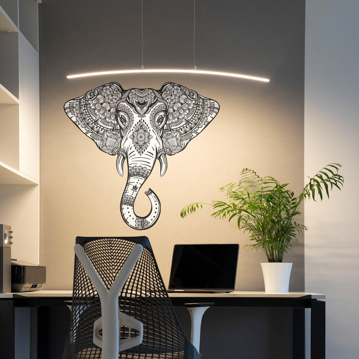 Tribal vinyl elephant wall sticker in a home office setting with modern decor and plant.