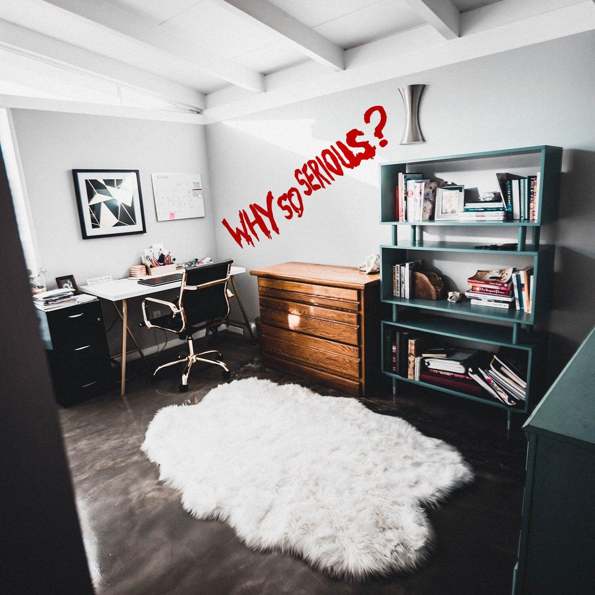 Home office interior showcasing a 'Why So Serious?' Joker vinyl sticker on the wall, with stylish furniture and decor.