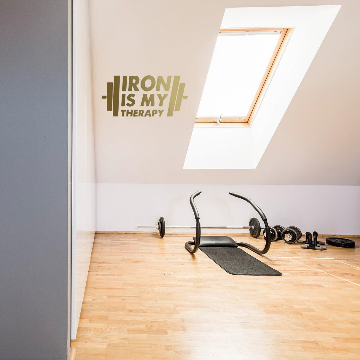 Bodybuilding vinyl wall sticker with the quote 'Iron is My Therapy' in a modern home gym décor