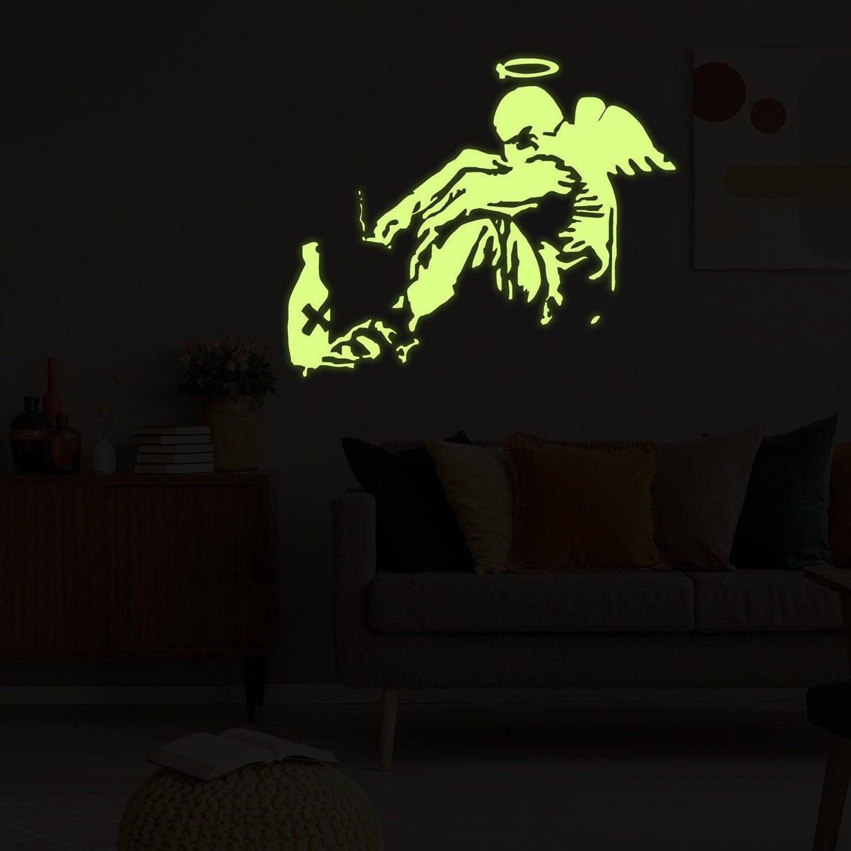 Glow in the dark Banksy fallen angel wall sticker showcasing glowing wings on a dark wall.