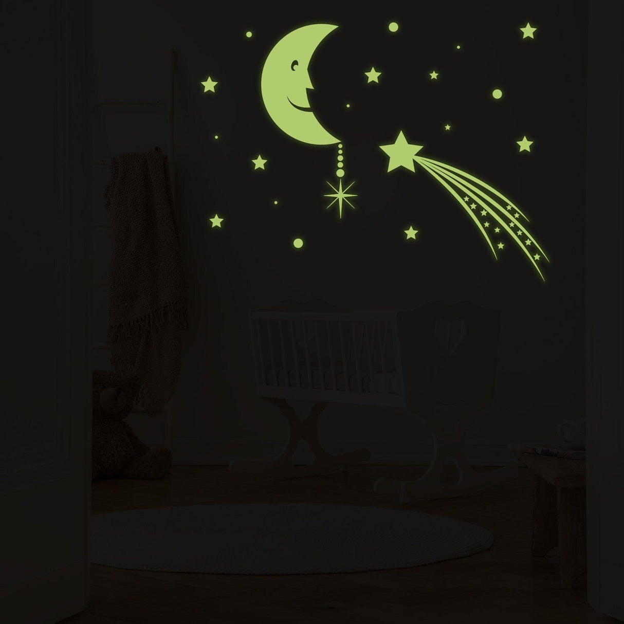Glowing moon with smiling face and falling star wall sticker, glowing in the dark, creating a dreamy room decor.