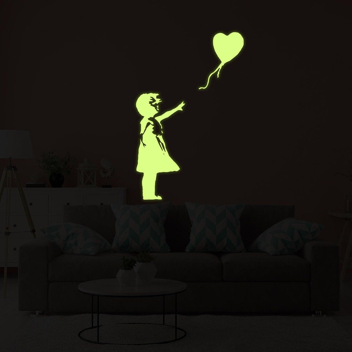 Glow in the dark vinyl wall art of a girl reaching for a heart-shaped balloon, perfect for kids' rooms.