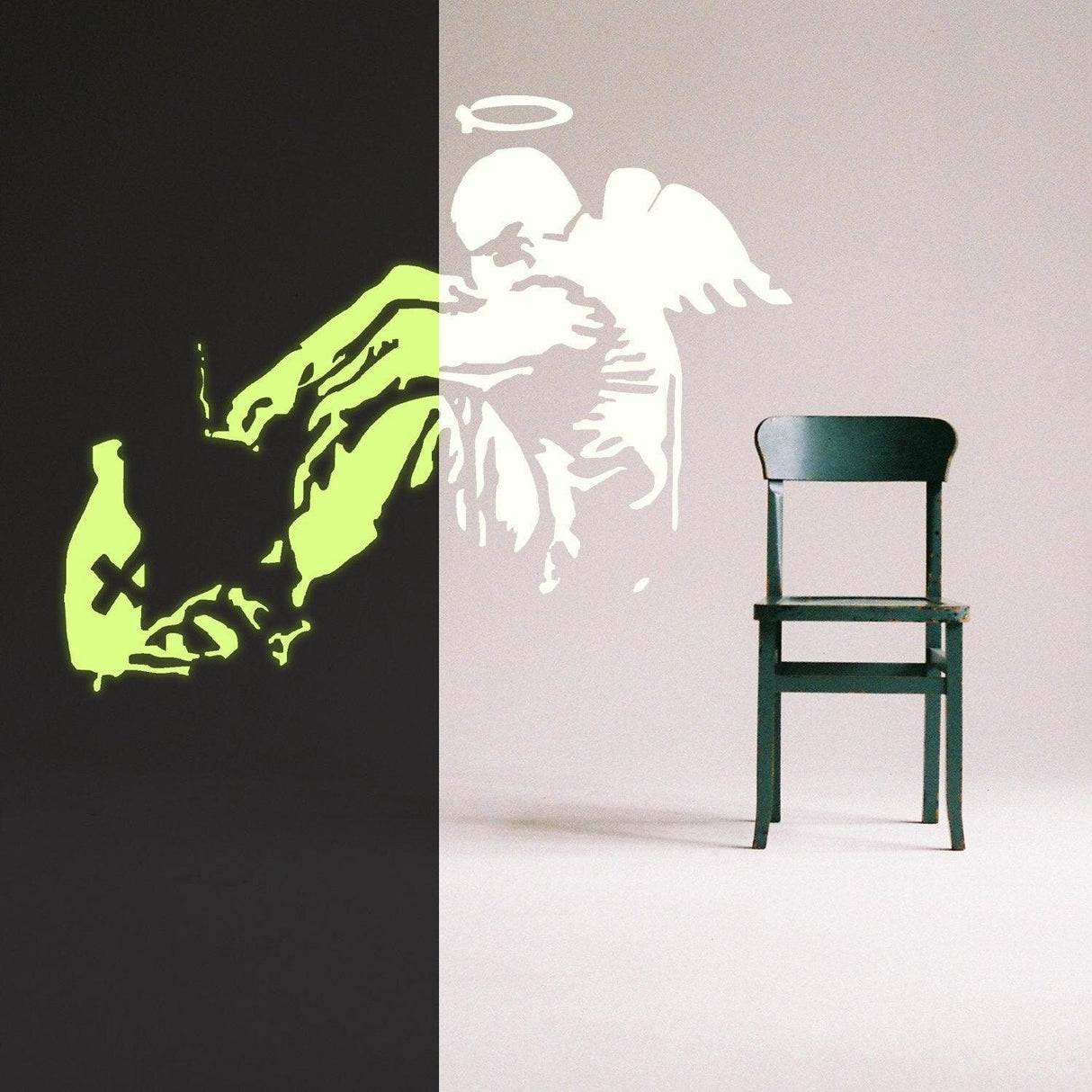 Glow in the dark Banksy fallen angel wall sticker beside an empty chair, showcasing urban street art style.