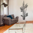 Bamboo wall vinyl sticker decal showcased in a stylish living room decor with a couch and glass table.