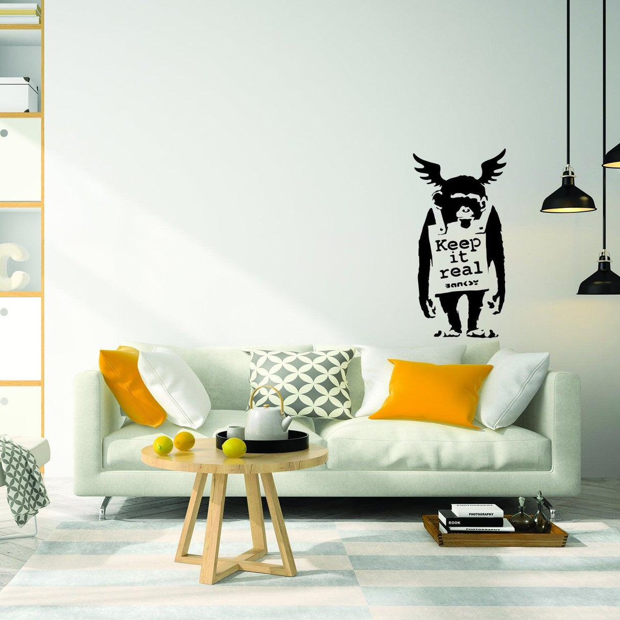 Banksy-style monkey wall sticker saying 'Keep it real' in modern living room with stylish decor.