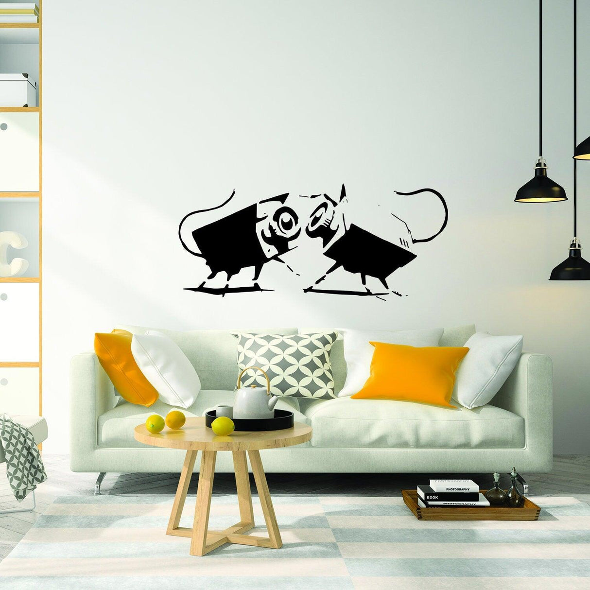 Banksy-style wall art of two playful mice in black and white on a modern living room wall.