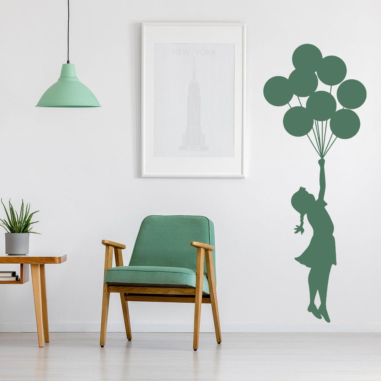 Balloon Girl Banksy vinyl wall sticker in a stylish nursery with green decor and furniture.