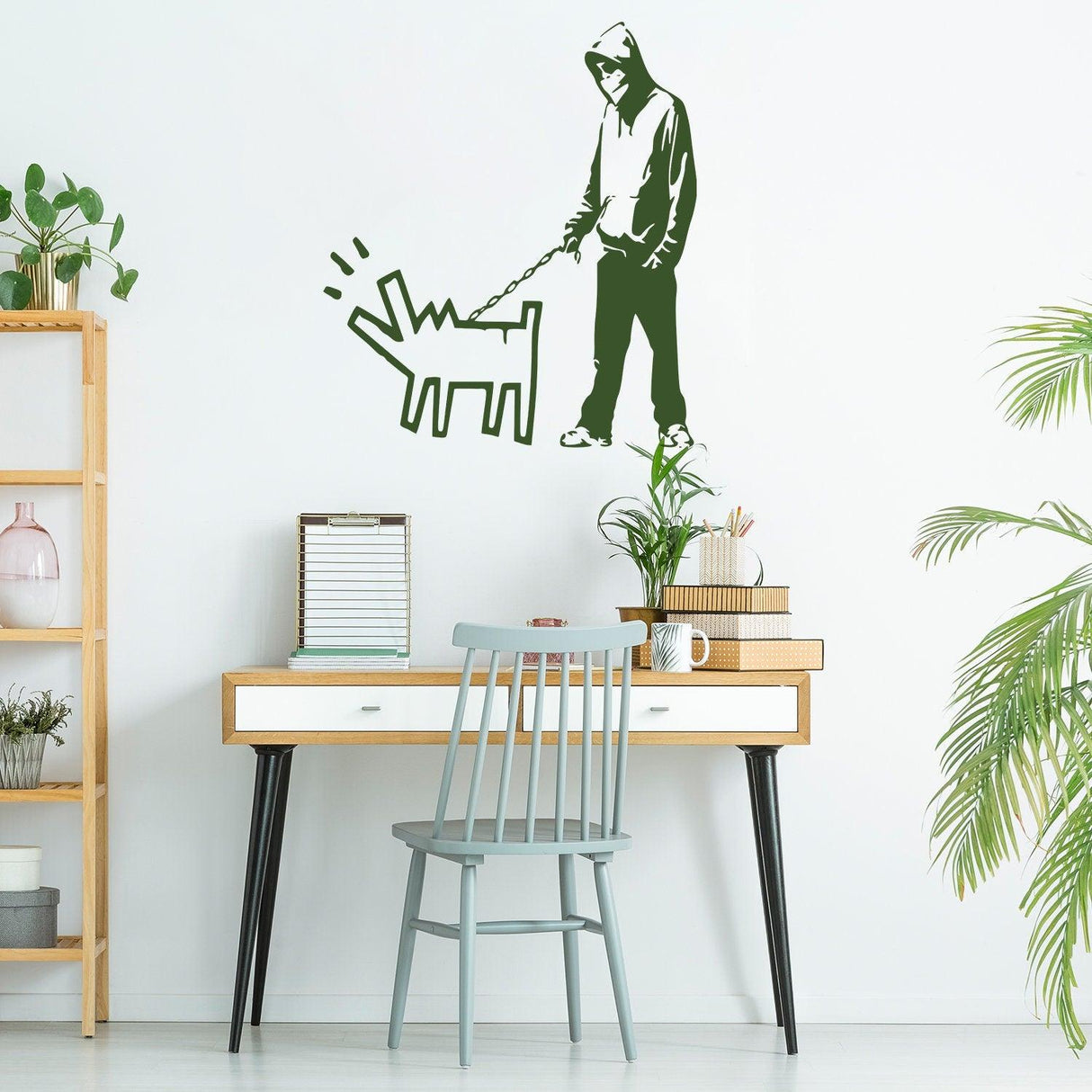 Banksy-inspired green vinyl wall sticker of a person walking a dog in a stylish room setting.