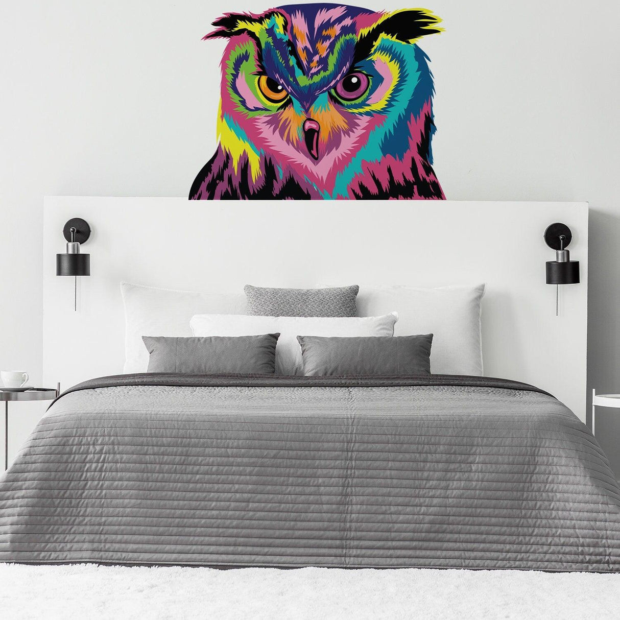 Colorful owl wall sticker on bedroom wall above a cozy bed, adding vibrant decor and charm to the space.