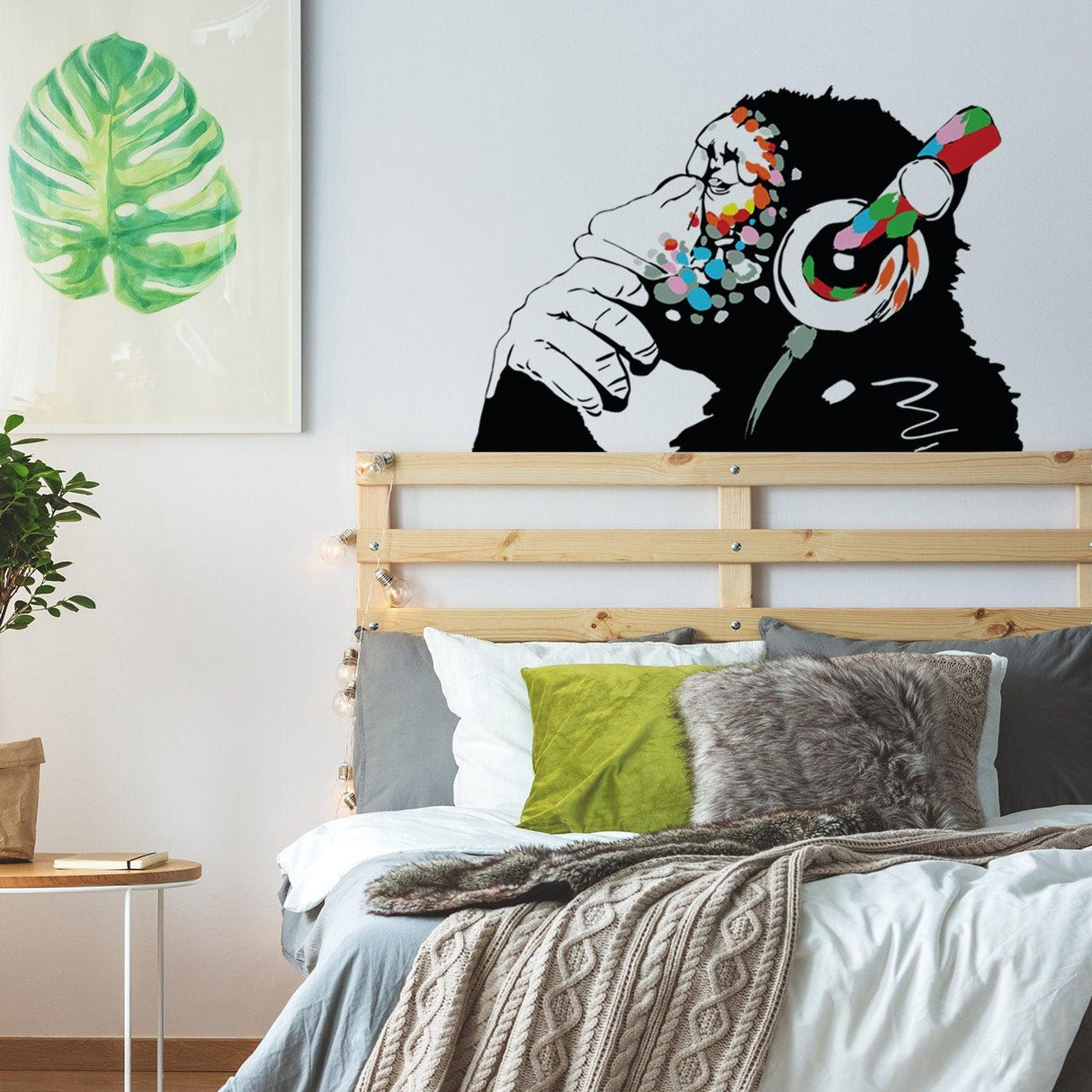 Colorful music wall art sticker featuring a monkey with headphones in a cozy bedroom setting.